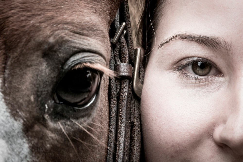 Girl and horse eyes close up