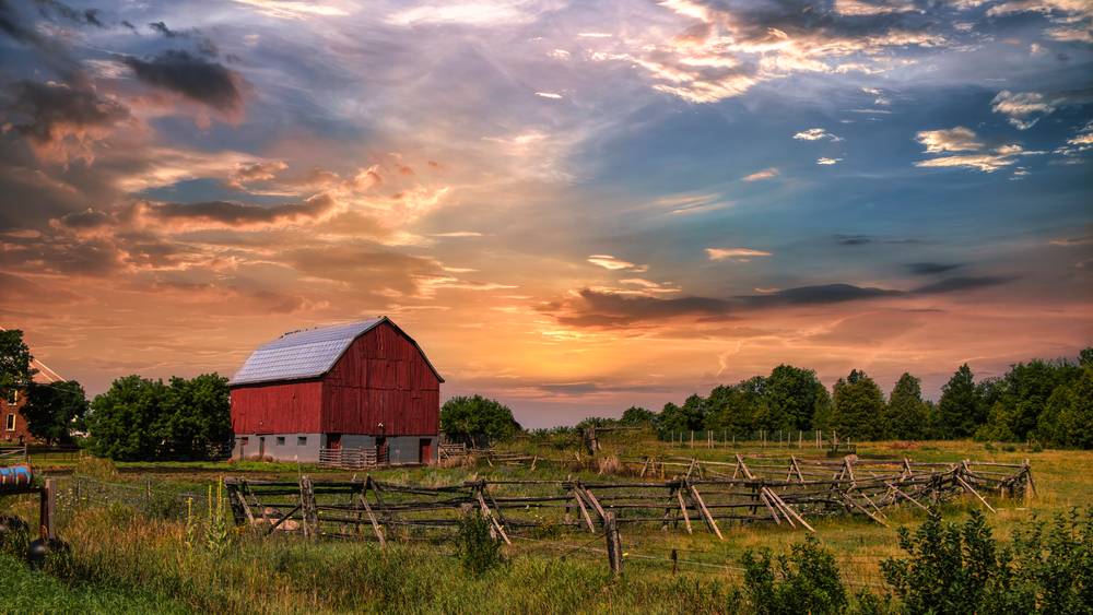 abandoned old barn with wooden fence