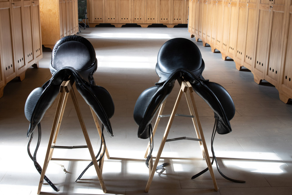 black saddles rest on saddle stands