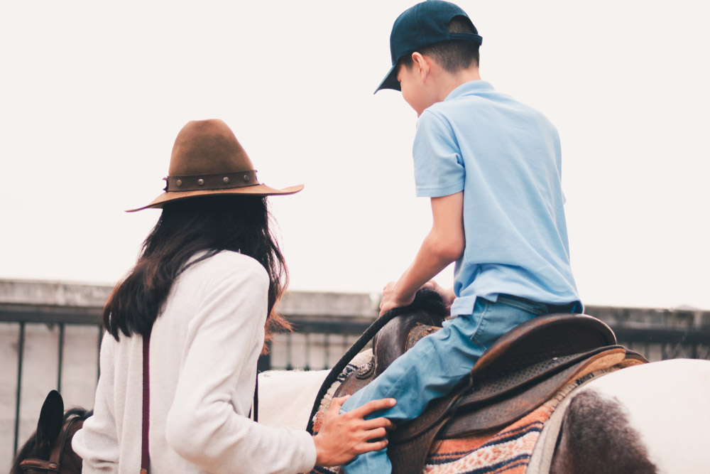 child with special needs is riding horse