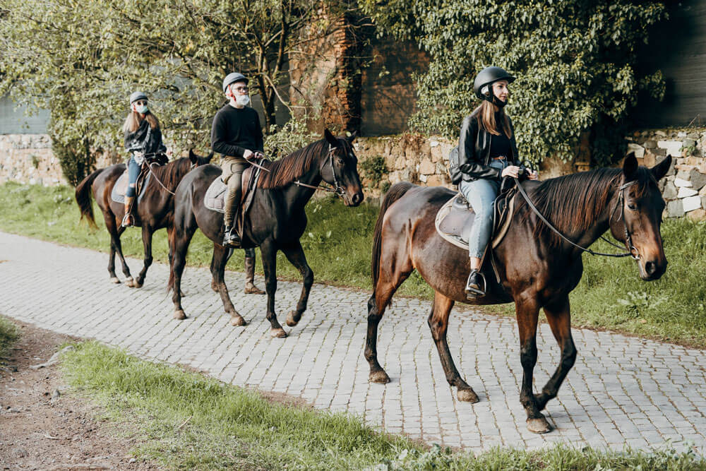 family is enjoying trail horse riding