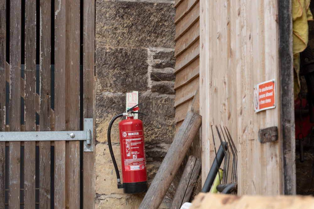 fire extinguisher attached to the barn door