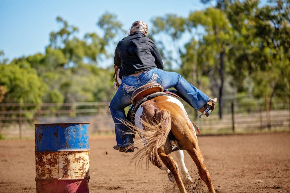 girl barrel racing back view