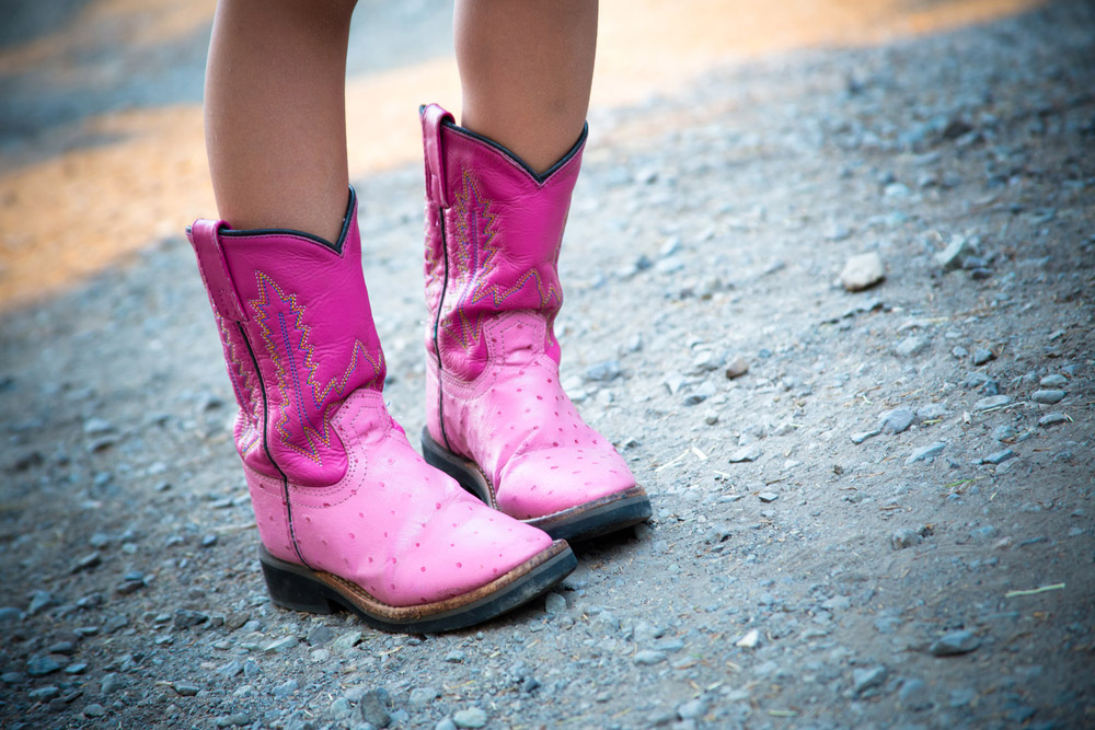 girl wearing pink cowboy boots