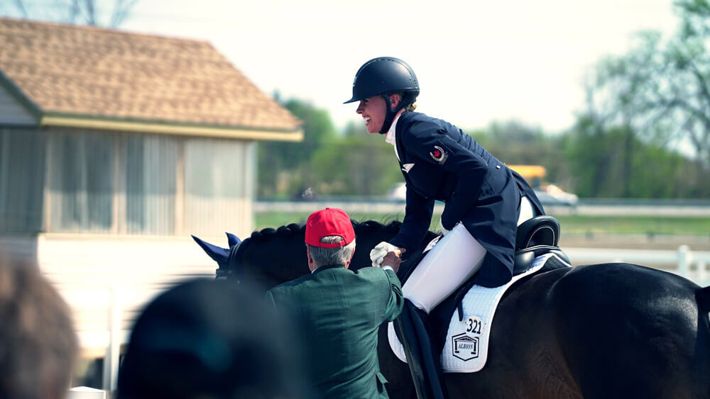 horsewoman is excited about the competition