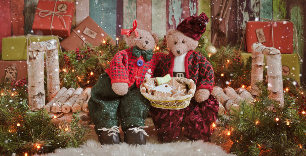 two teddy bears on a wooden bench