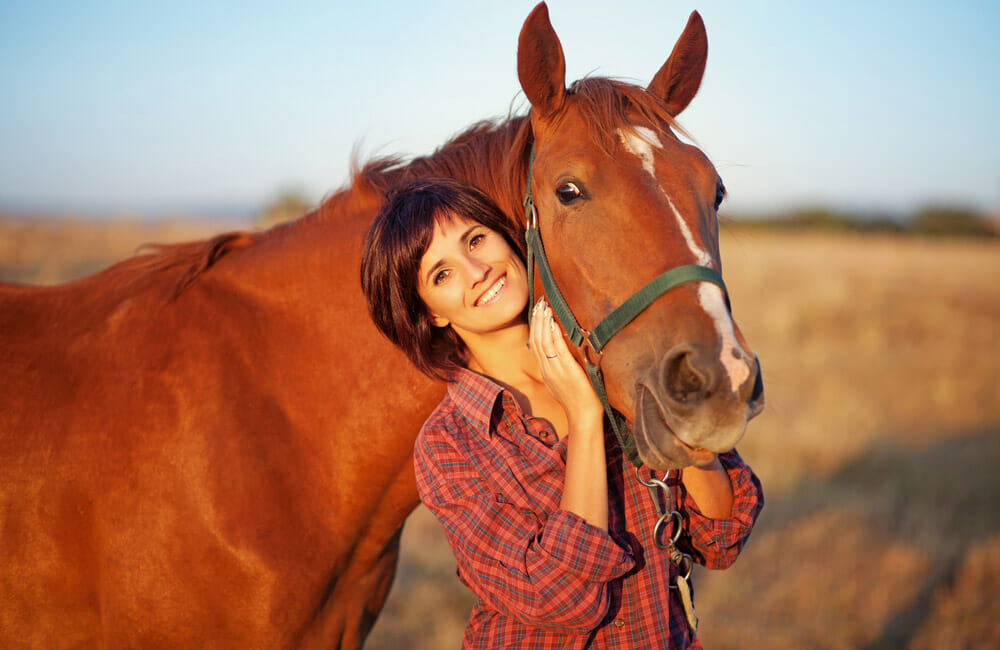 woman and horse are smiling