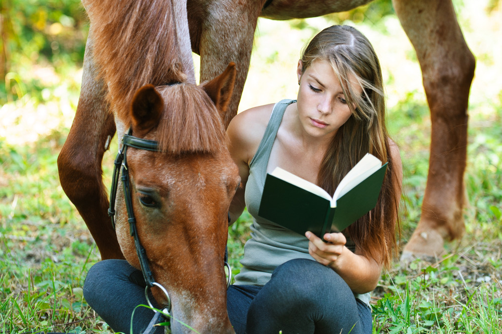 woman reading a horse planner