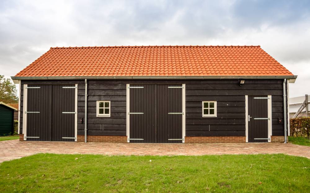 wooden horse barn with orange roof